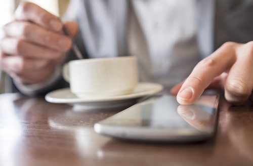 Male touching smartphone restaurant